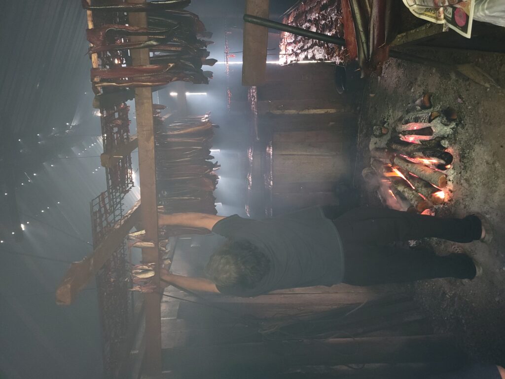 TJ in his smokehouse, putting up the freshly processed herring.